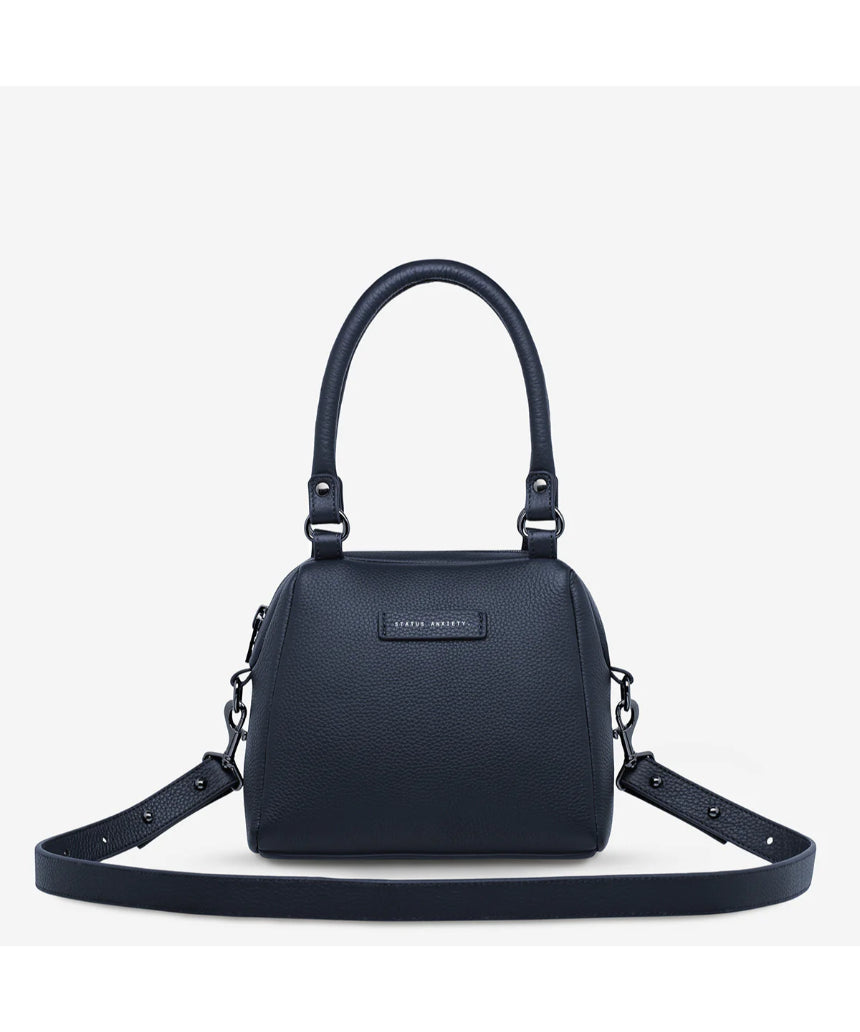 Mini Mountains Bag by Status Anxiety, midnight blue leather bag with minimalist mountain design, front view.