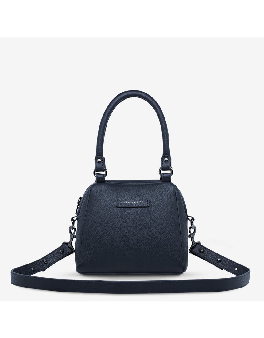 Mini Mountains Bag by Status Anxiety, midnight blue leather bag with minimalist mountain design, front view.