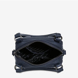 Open midnight blue Status Anxiety Mini Mountains bag showing its compact design and stylish leather strap.