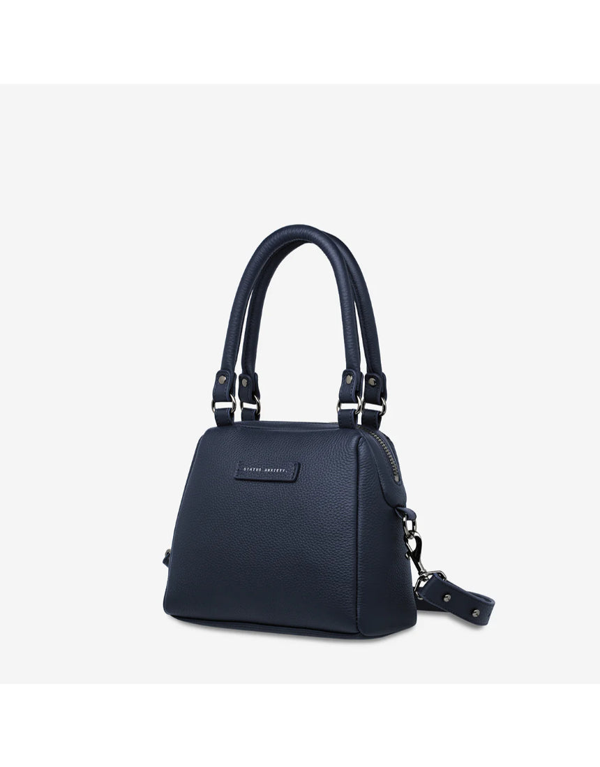 Status Anxiety Mini Mountains bag in midnight blue, side and front view showing compact bags with mountain-inspired design.