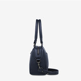 Status Anxiety Mini Mountains Bag in midnight blue shown from the side, featuring a compact, stylish bags design with a sleek finish.
