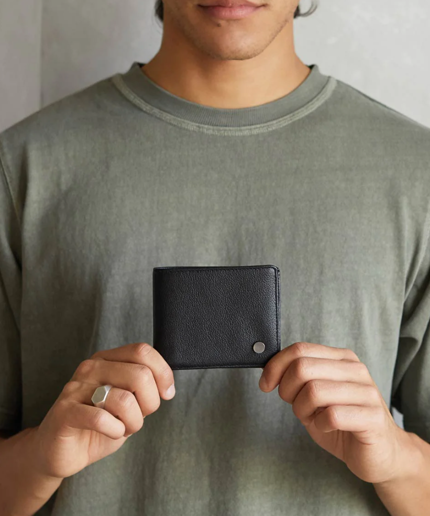 Black Leonard Wallet by Status Anxiety, a sleek leather wallet with multiple card slots and a minimalist design.