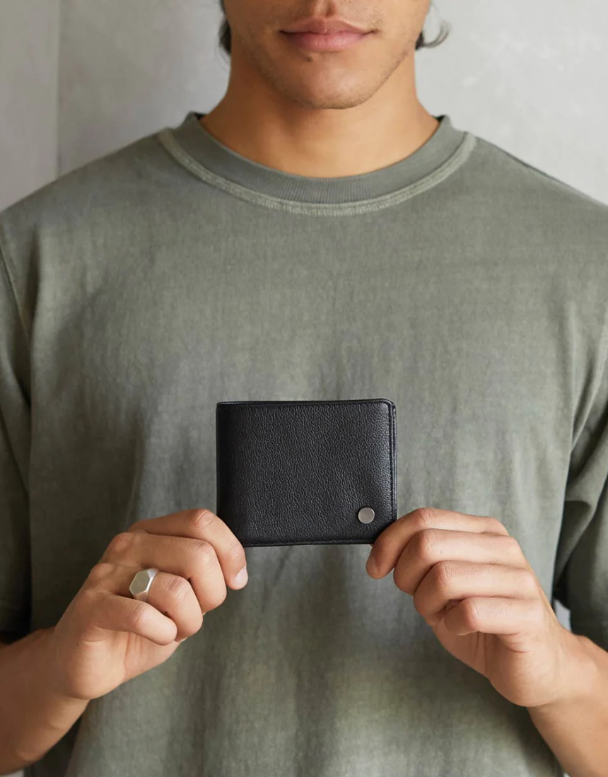 Black Leonard Wallet by Status Anxiety, a sleek leather wallet with multiple card slots and a minimalist design.