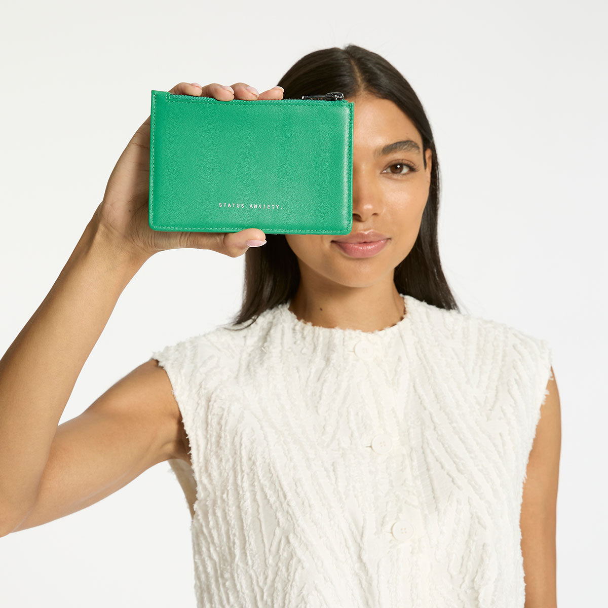 Status Anxiety Gone Again Wallet in Emerald Nappa leather, showcasing its sleek design and vibrant green color.