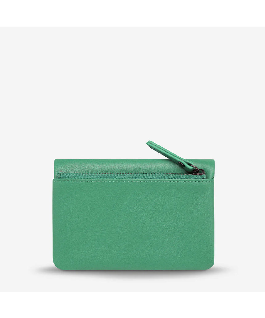 Status Anxiety Is Now Better Wallet with smooth emerald green leather and sleek design, perfect for organizing cards and cash.