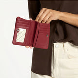 Status Anxiety Is Now Better Wallet in Rouge, featuring a sleek design and multiple card slots for stylish organization.
