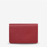 Status Anxiety Is Now Better Wallet in Rouge, smooth leather front with multiple card slots and sleek design.