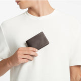 Status Anxiety Jonah Wallet in chocolate color, showcasing slim leather design with multiple card slots and compact size.