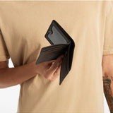 Status Anxiety Leonard Wallet in chocolate brown, featuring card slots and a sleek leather design.