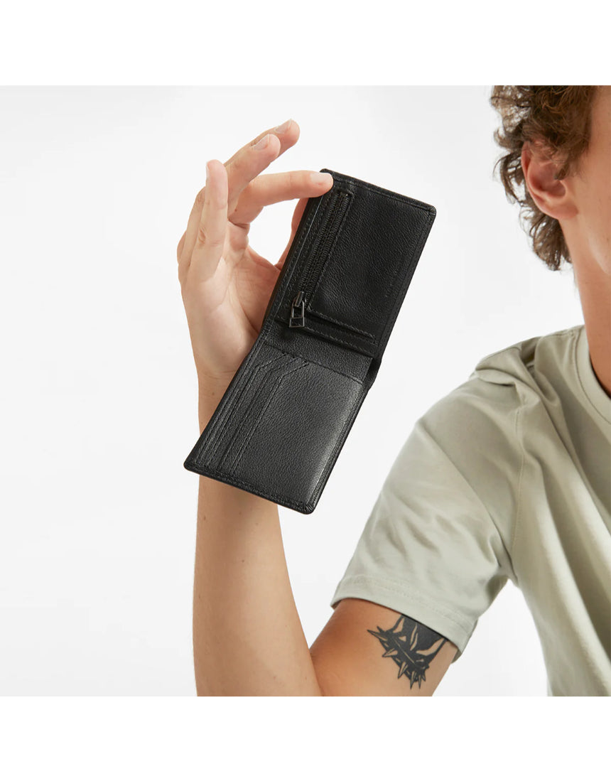 Black Status Anxiety Otis Wallet with multiple card slots and compact design, shown with lifestyle background.