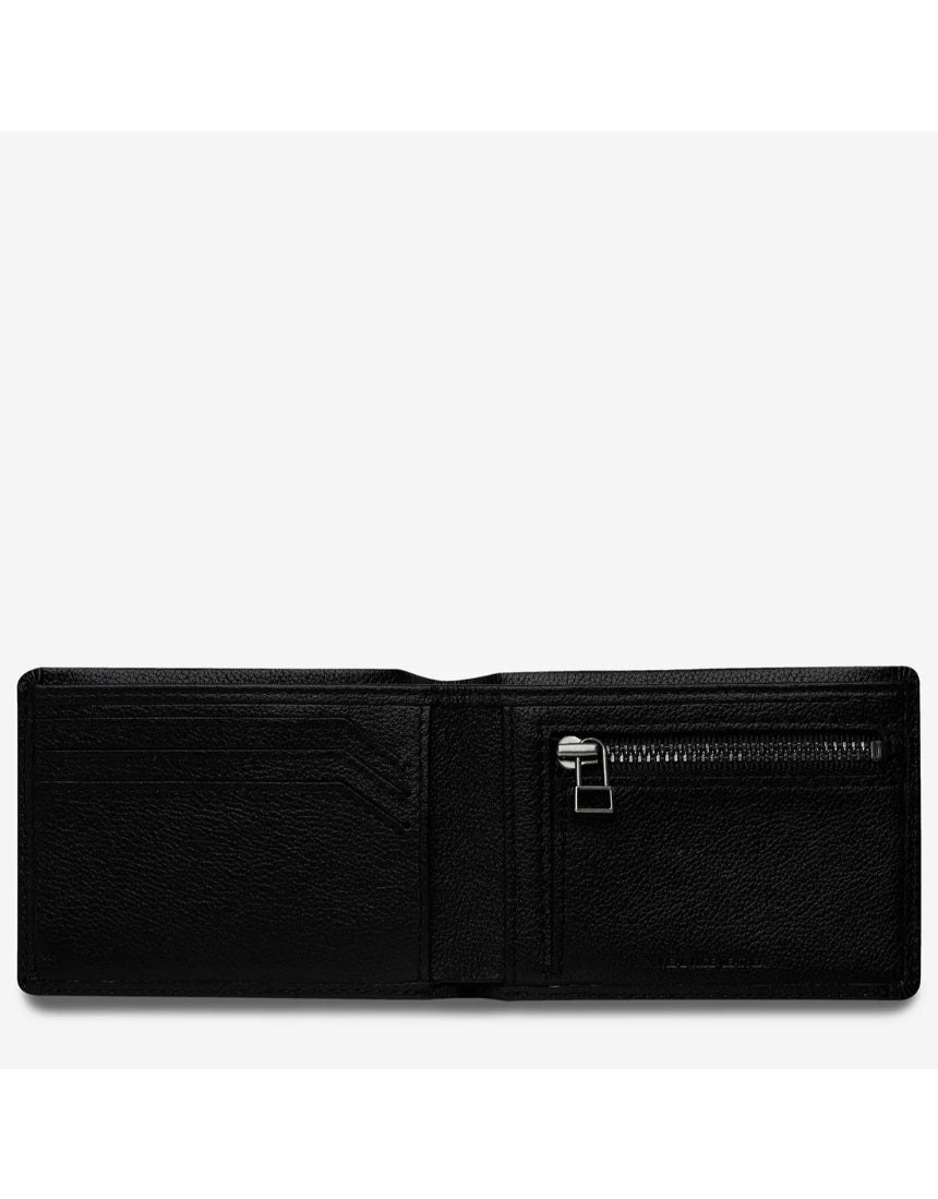 Open black Status Anxiety Otis Wallet showing card slots and cash compartment, made of leather with a sleek design.
