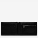Open black Status Anxiety Otis Wallet showing card slots and cash compartment, made of leather with a sleek design.