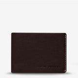 Status Anxiety Otis Wallet in chocolate brown, compact leather wallet with multiple card slots and a minimalist design.