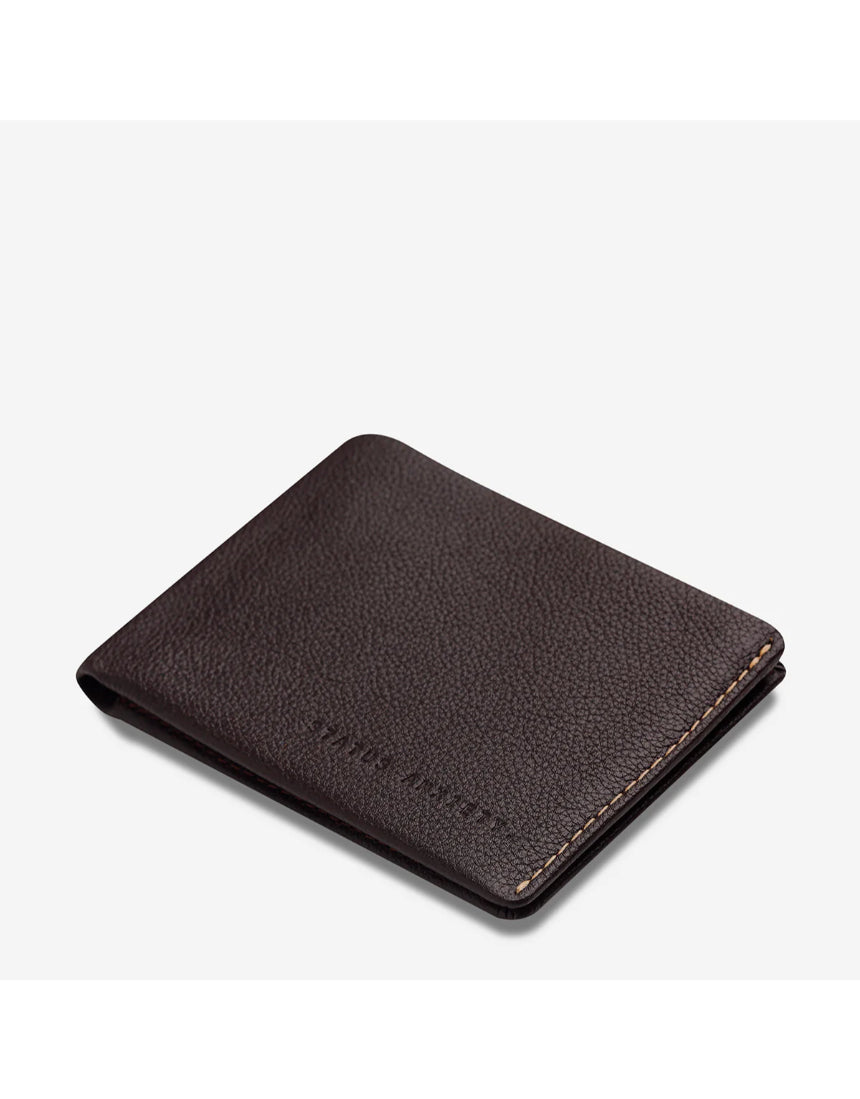 Status Anxiety Otis Wallet in chocolate brown, showing the top-angle view of its compact leather design.