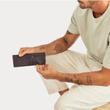 Status Anxiety Otis Wallet in chocolate color, featuring multiple card slots and a sleek, minimalist design.