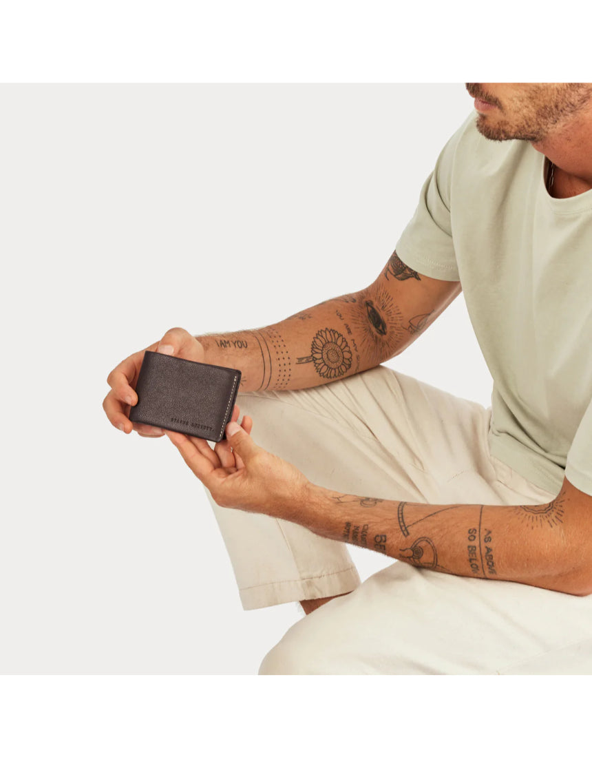 Status Anxiety Otis Wallet in chocolate color showing multiple card slots and sleek leather design.