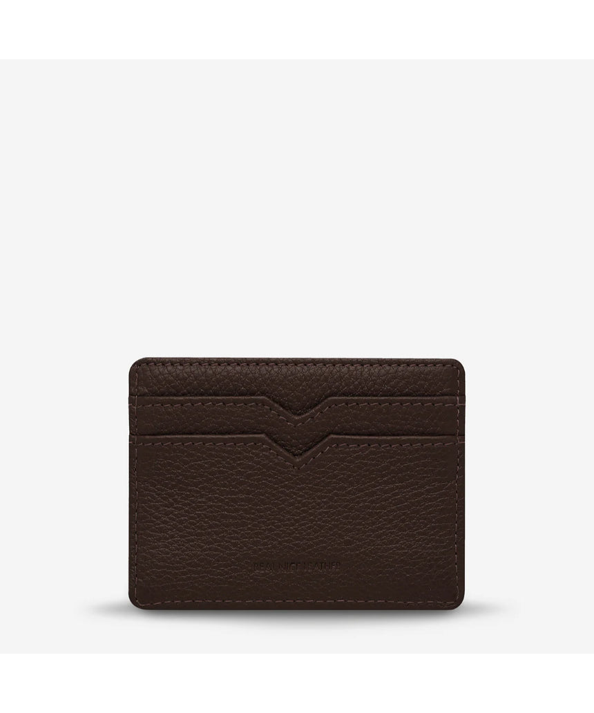 Status Anxiety Together For Now Cocoa wallet, made of leather, showing the back with stitched design and brand logo.