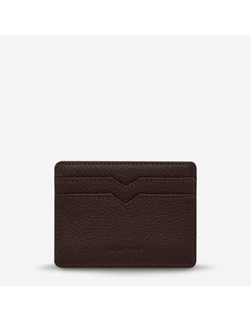Status Anxiety Together For Now Cocoa wallet, made of leather, showing the back with stitched design and brand logo.