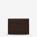 Status Anxiety Together For Now Cocoa wallet, a stylish leather accessory with a front view showing its textured surface and compact design.
