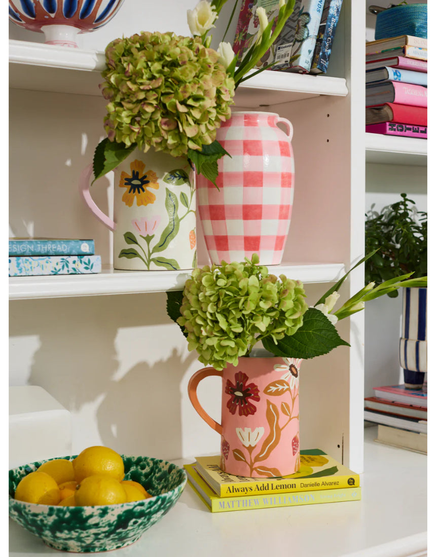 Jones & Co Meadow Jug in pink with a smooth, rounded shape, styled with flowers on a wooden table.
