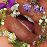 Suzy Lipsticks Chestnut Matte lipstick, showing the rich brown shade in a sleek tube on a neutral background.