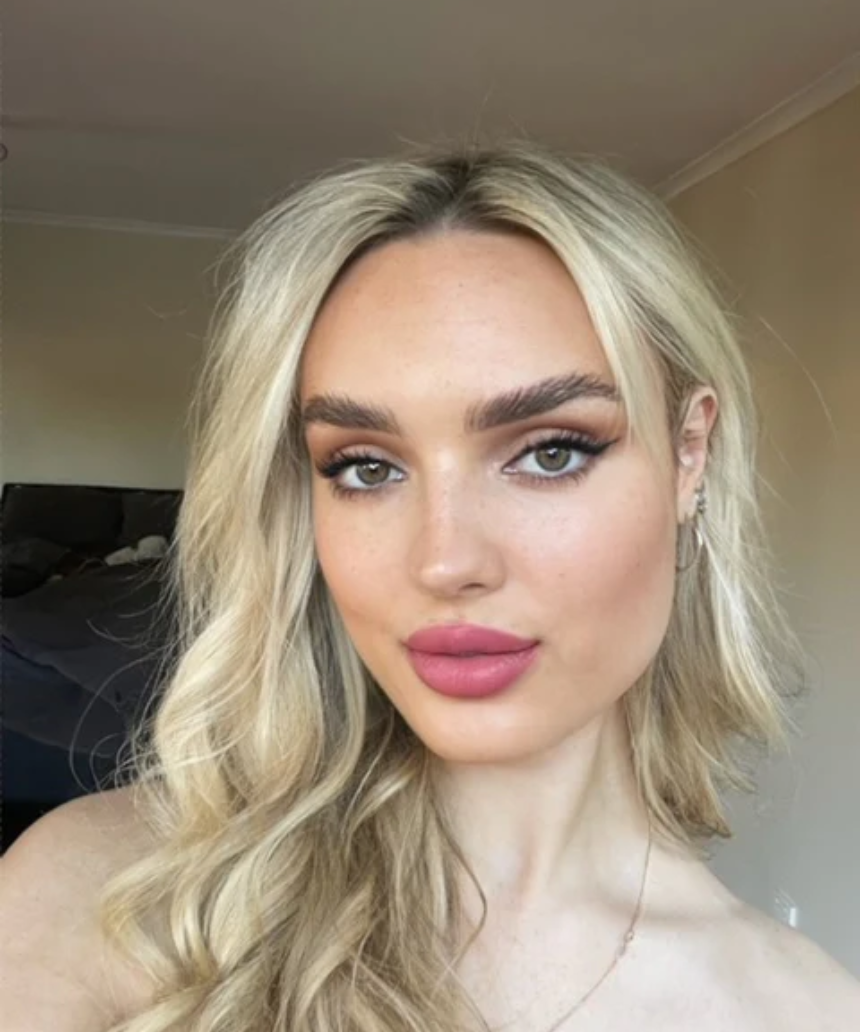 Suzy Lipsticks Miss Cassandra Peony matte lipstick tube with the lipstick partially extended, showcasing soft pink shade.