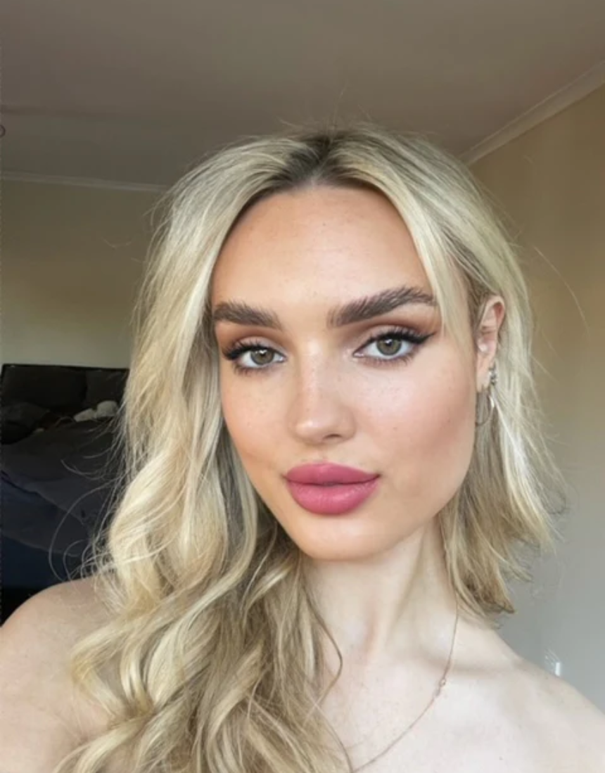 Suzy Lipsticks Miss Cassandra Peony matte lipstick tube with the lipstick partially extended, showcasing soft pink shade.