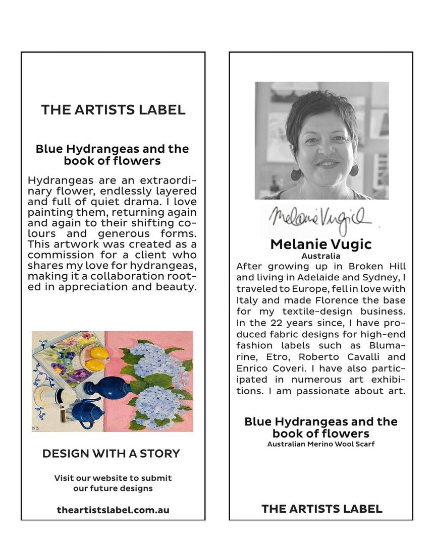 Wool scarf by The Artists Label featuring blue hydrangeas and floral designs, hanging with a branded tag.