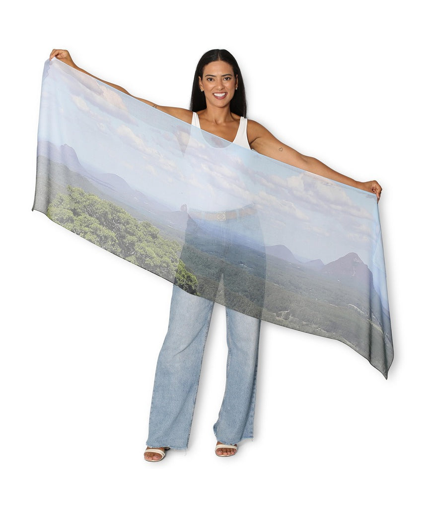 The Artists Label Glass House Mountains scarf featuring a vibrant mountain landscape pattern on soft fabric.