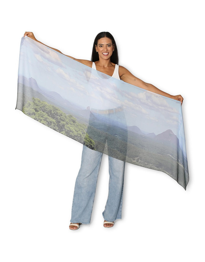 The Artists Label Glass House Mountains scarf featuring a vibrant mountain landscape pattern on soft fabric.