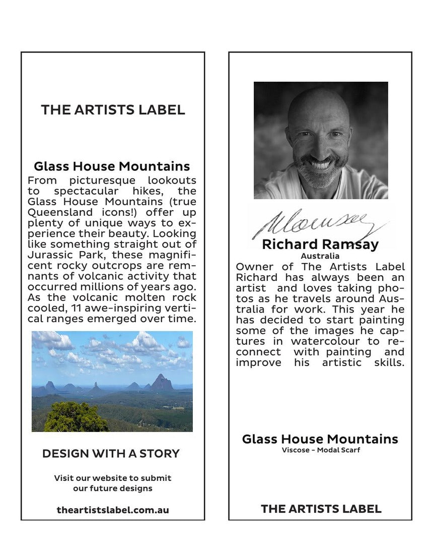 The Artists Label Glass House Mountains scarf featuring a scenic mountain design on soft fabric, displayed hanging with a tag.