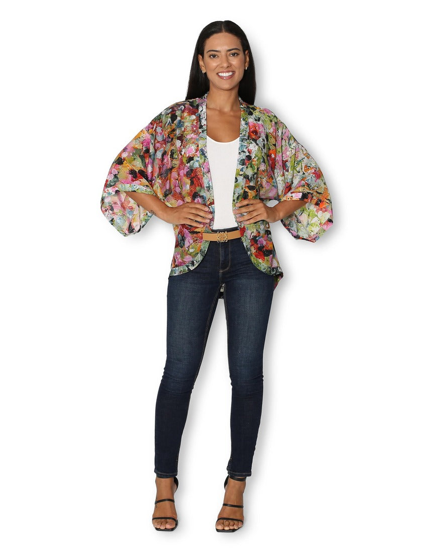 The Artists Label Julie’s Garden silk kimono displaying a floral pattern, front view with flowing fabric and elegant design.