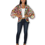 The Artists Label Julie’s Garden silk kimono displaying a floral pattern, front view with flowing fabric and elegant design.