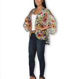 Side view of The Artists Label Julie’s Garden silk kimono with floral pattern and flowing fabric, showcasing elegant Japanese-inspired design.