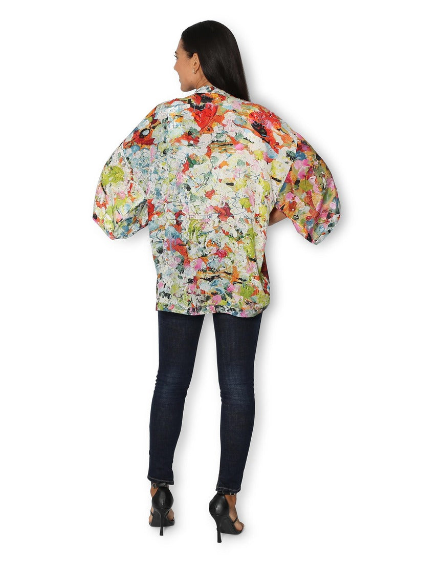 Back view of The Artists Label Julie’s Garden silk kimono with floral patterns and flowing fabric.