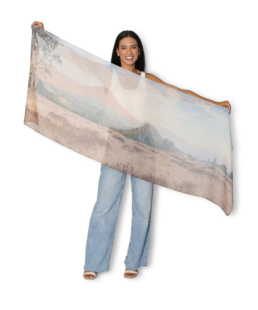The Artists Label Kiewa Valley Autumn Scarf featuring vibrant fall colors and a detailed scenic pattern on soft fabric.