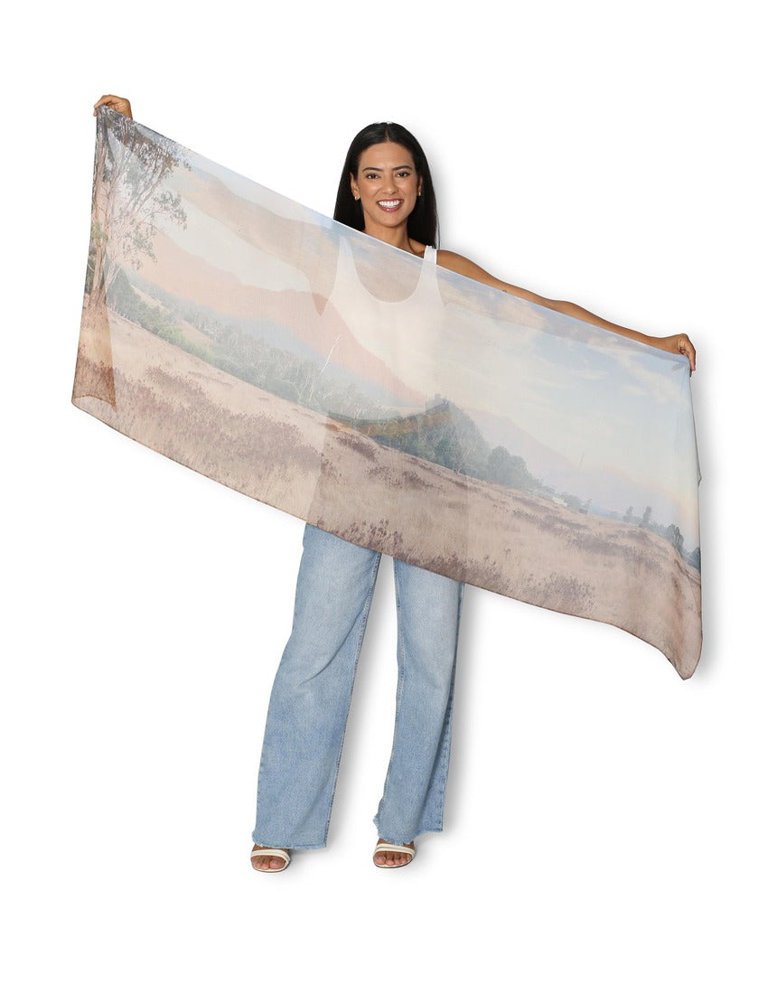 The Artists Label Kiewa Valley Autumn Scarf featuring vibrant fall colors and a detailed scenic pattern on soft fabric.