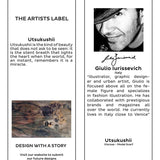 The Artists Label Utsukushii scarf displayed hanging with a tag, showcasing its soft fabric and elegant design.