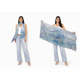 The Artists Label viscose modal scarf featuring a "Swept Beneath the Sea" design with ocean-inspired patterns in blue and white.
