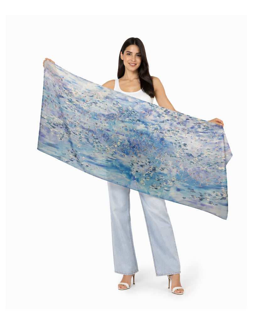 The Artists Label viscose modal scarf featuring a "Swept Beneath The Sea" design with flowing, ocean-inspired patterns and vibrant colors.