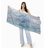The Artists Label viscose modal scarf featuring a "Swept Beneath The Sea" design with flowing, ocean-inspired patterns and vibrant colors.