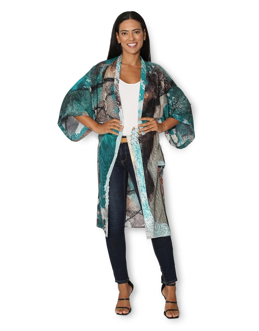 Front view of The Artists Label Winter Dance long silk kimono with intricate patterns and elegant drape, showcasing luxurious silk fabric.