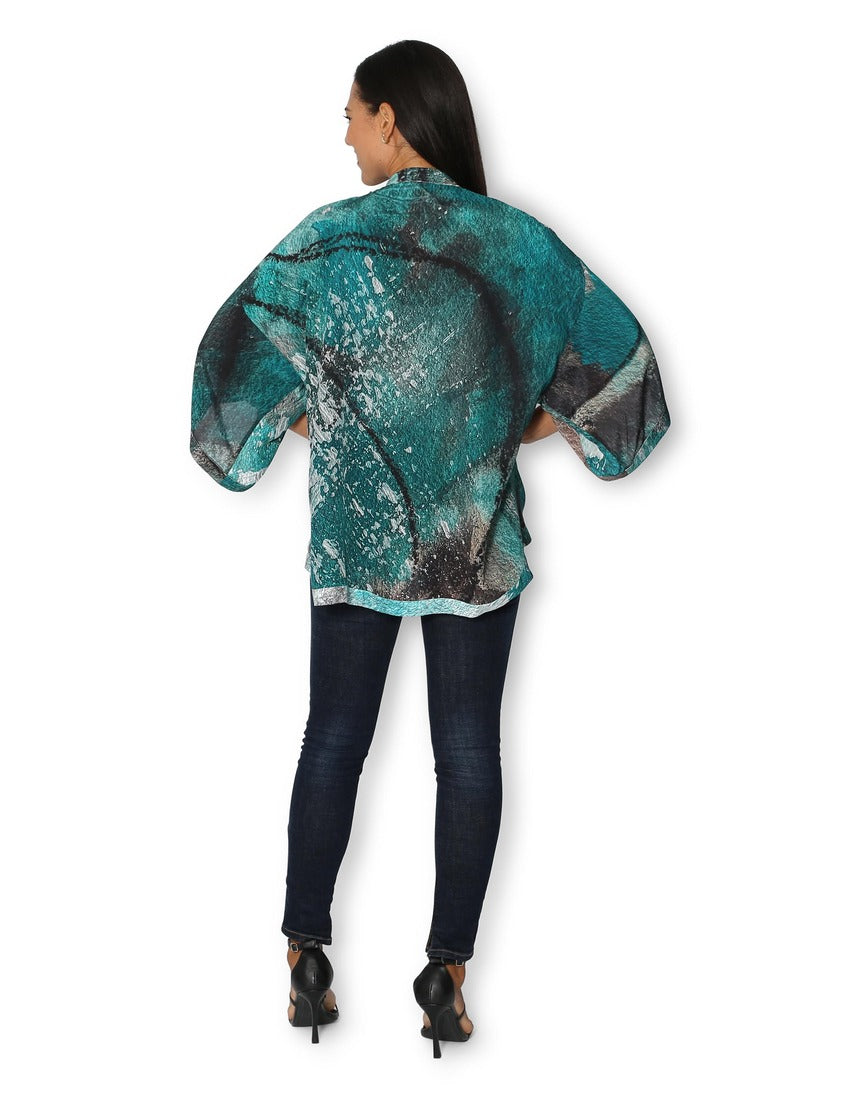 Back view of The Artists Label Winter Dance Silk Kimono featuring intricate patterns and flowing silk fabric.