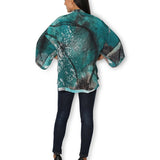 Back view of The Artists Label Winter Dance Silk Kimono featuring intricate patterns and flowing silk fabric.