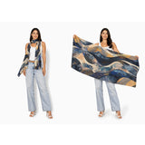 Wool scarf with celestial wave pattern from The Artists Label, featuring soft fabric and artistic design in shades of blue and gray.