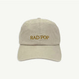 Banabae Rad Pop baseball cap in stone color, featuring a classic curved brim and adjustable strap, casual streetwear style.