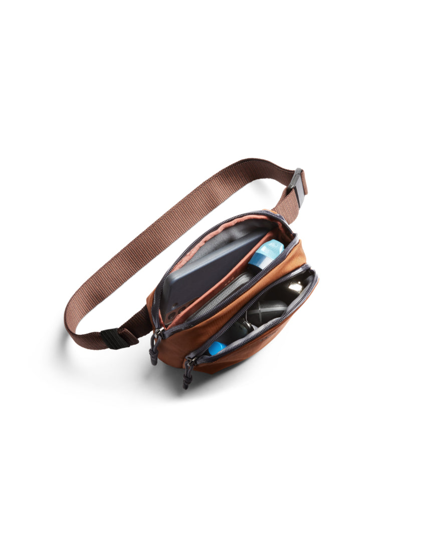 Bellroy Venture Hip Pack in bronze with adjustable strap and multiple compartments, designed for convenient everyday carrying.