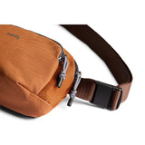 Bellroy Venture Hip Pack in bronze, showcasing its compact design and adjustable strap for easy carry and storage.