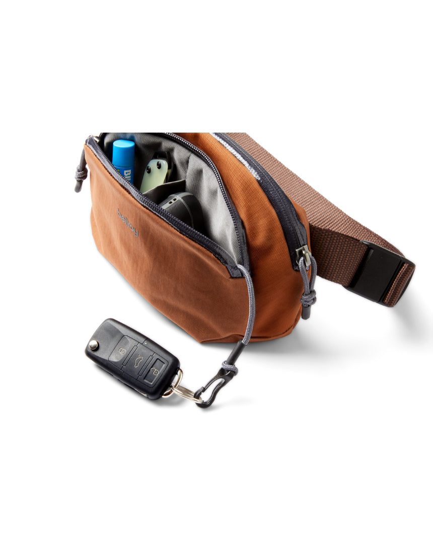 Bellroy Venture Hip Pack in bronze shown with adjustable strap and multiple compartments for organized carrying.