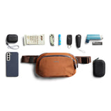 Bellroy Venture Hip Pack in bronze, compact travel bag with multiple compartments and adjustable strap, designed for convenience.